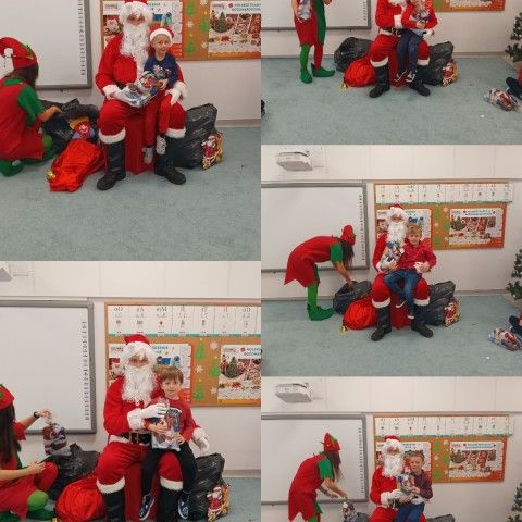 Powiększ obraz: Mikołaj wręcza dzieciom prezenty